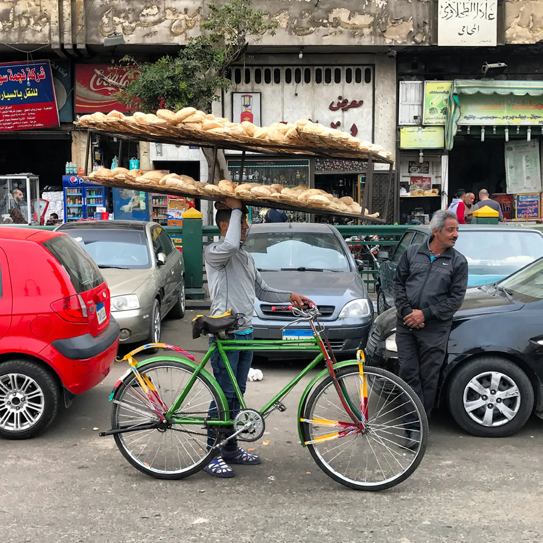 bread vendor balancing rack on bicycle